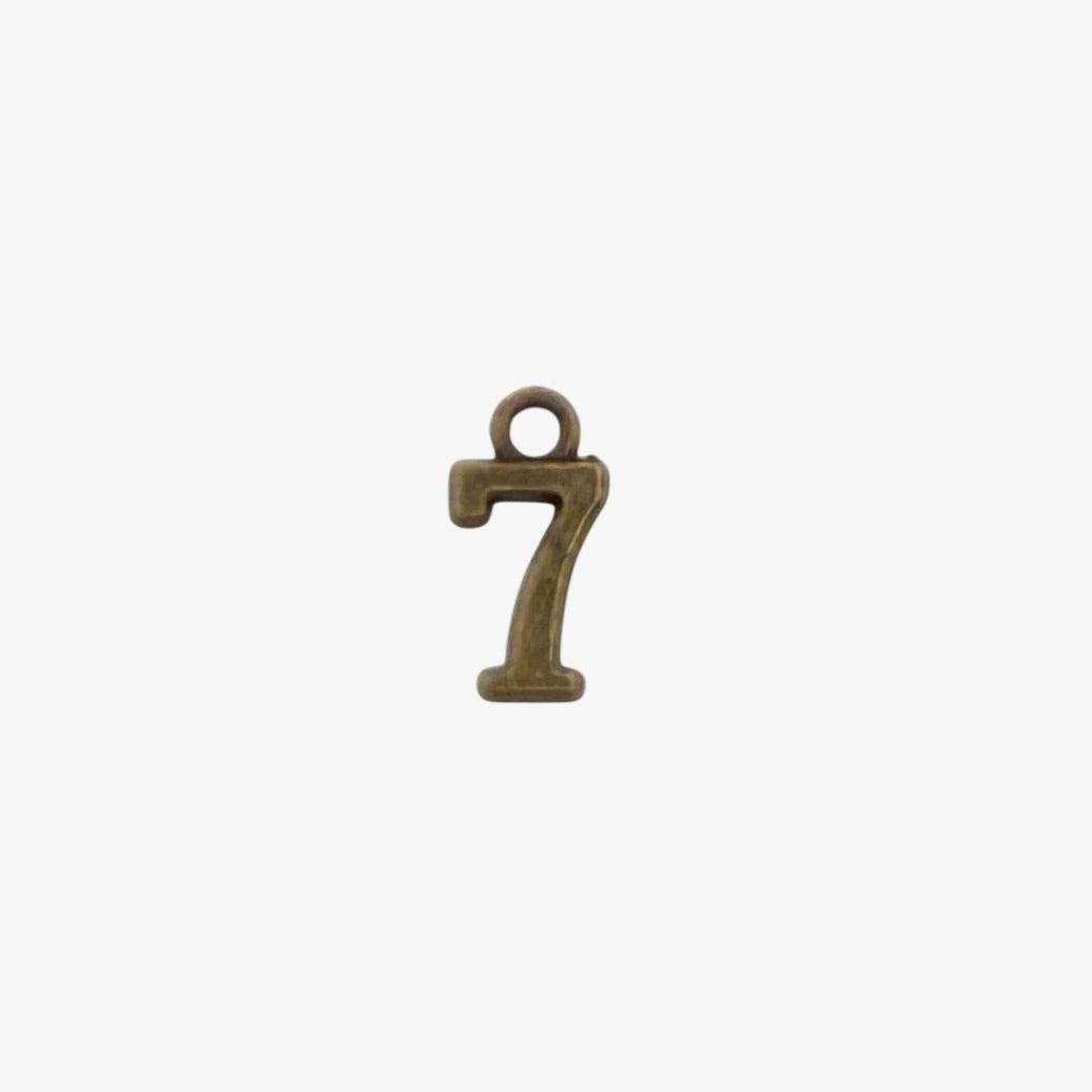 Bronze-colored number '7' charm on a white background