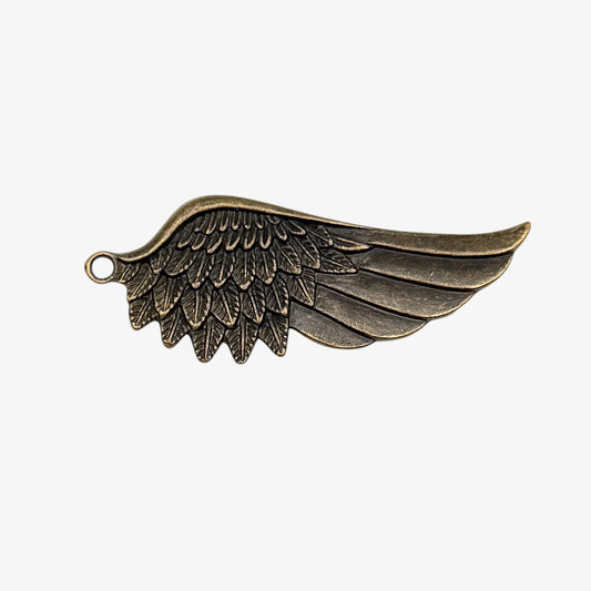 Bronze wing-shaped pendant on a white background