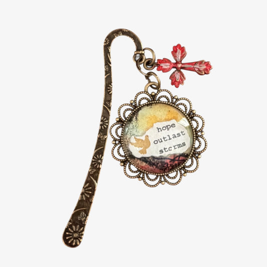 Decorative bookmark with a quote 'hope outlasts storms' on a white background