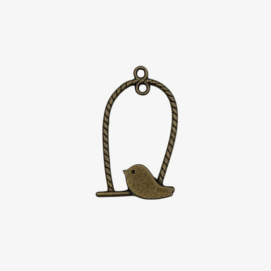 Bronze bird charm on a rope against a white background
