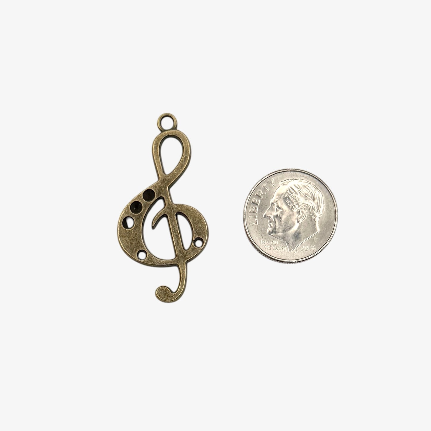 Bronze treble clef pendant on a white background