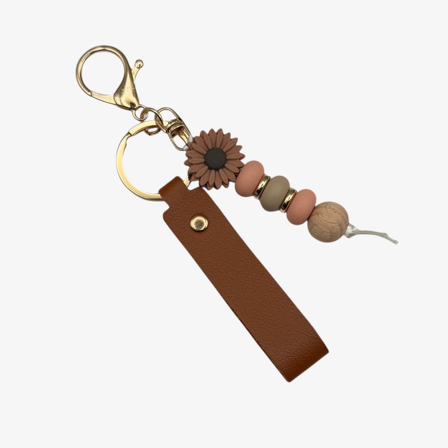 Brown keychain with beads and a sunflower charm on a white background