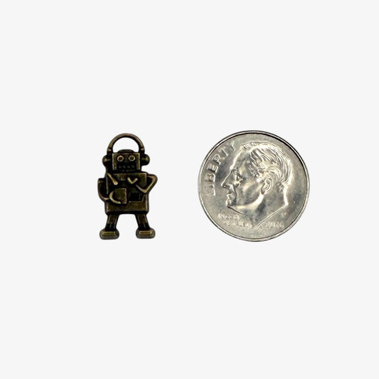 Small bronze robot charm on a white background