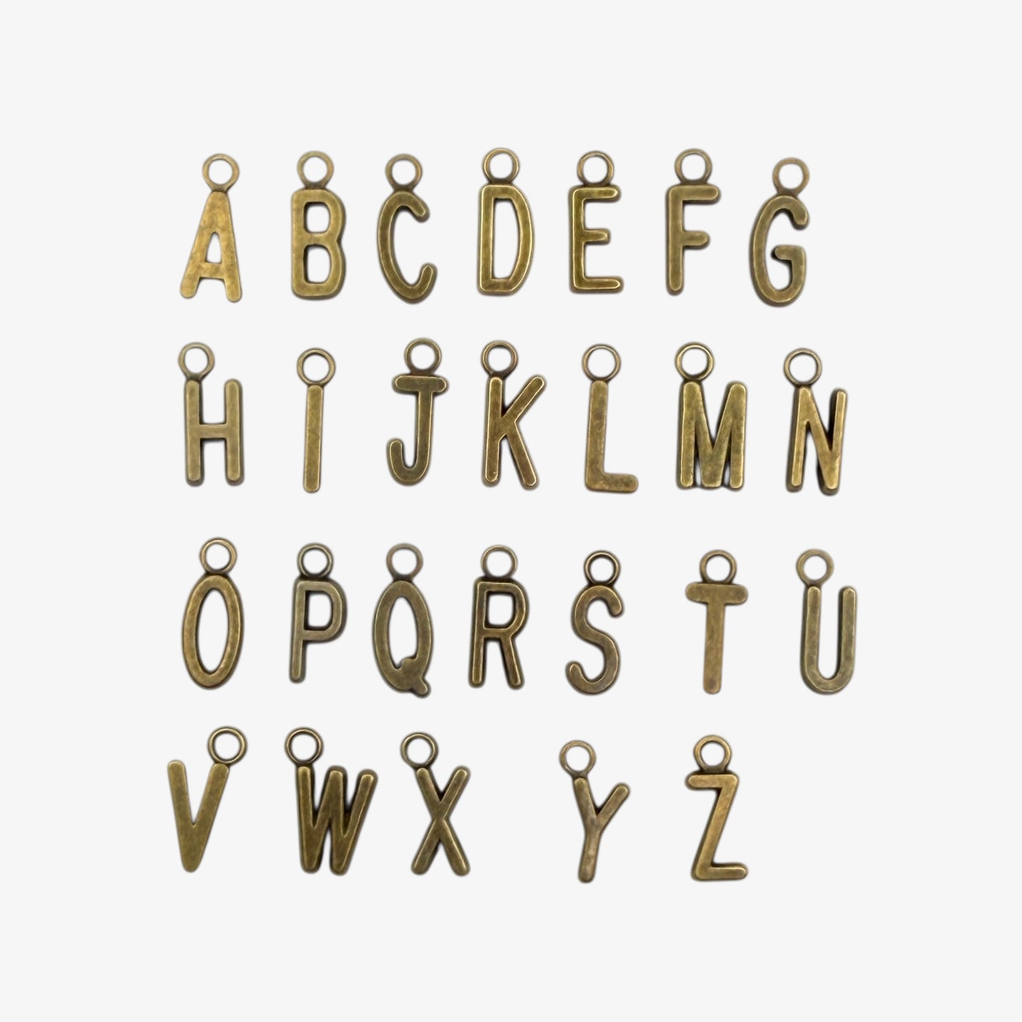 Bronze-colored alphabet letter charms on a white background