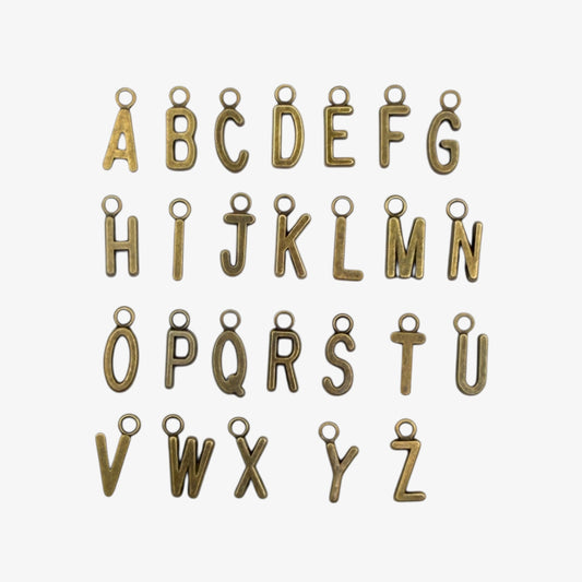 Bronze-colored alphabet letter charms on a white background