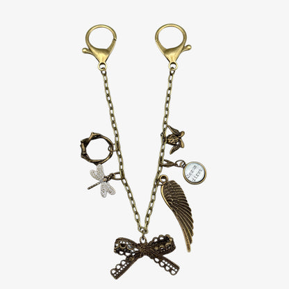 Decorative keychain with various charms on a white background