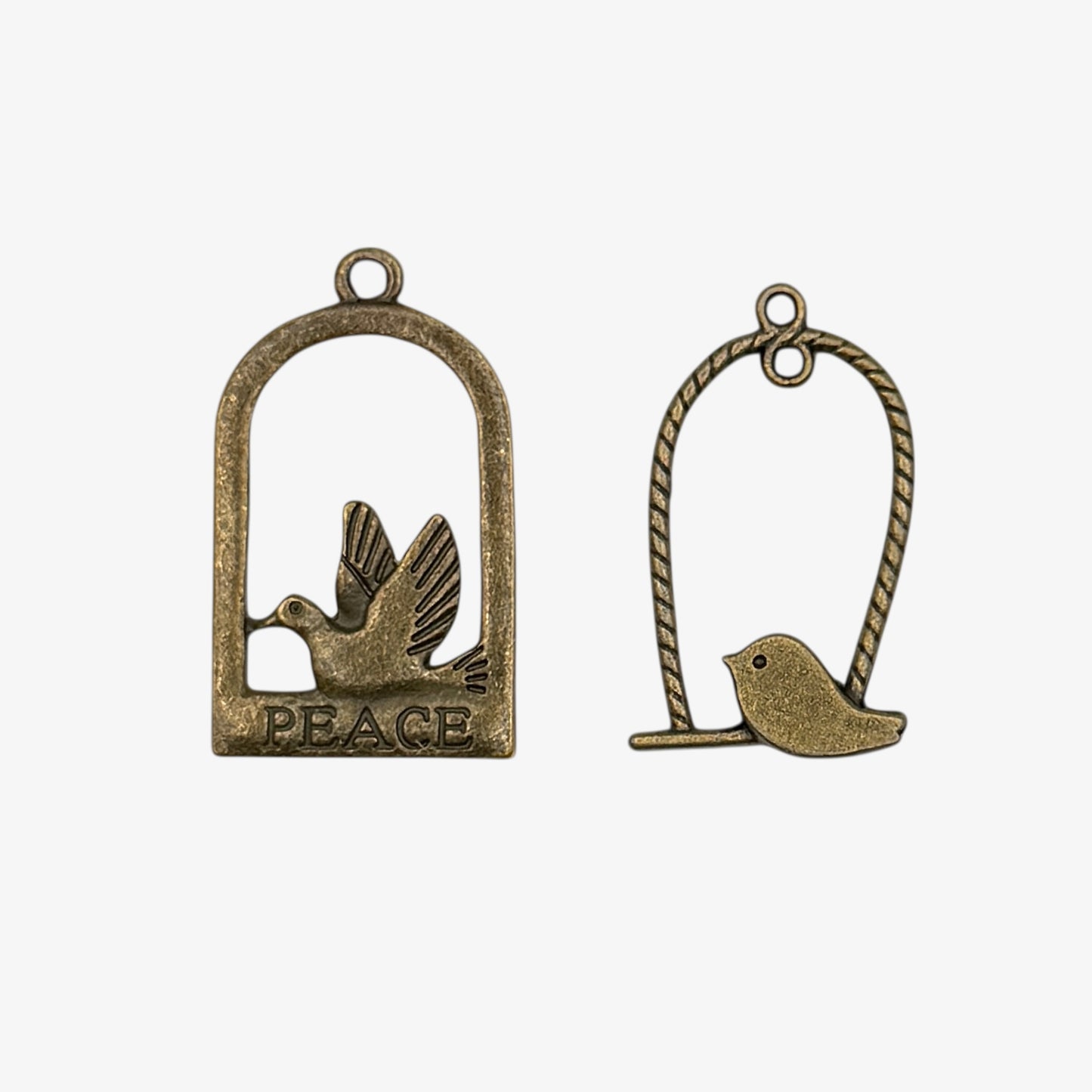 Bronze charms with birds on a perch