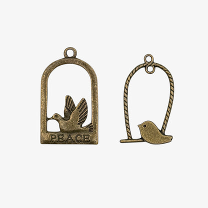 Bronze charms with birds on a perch