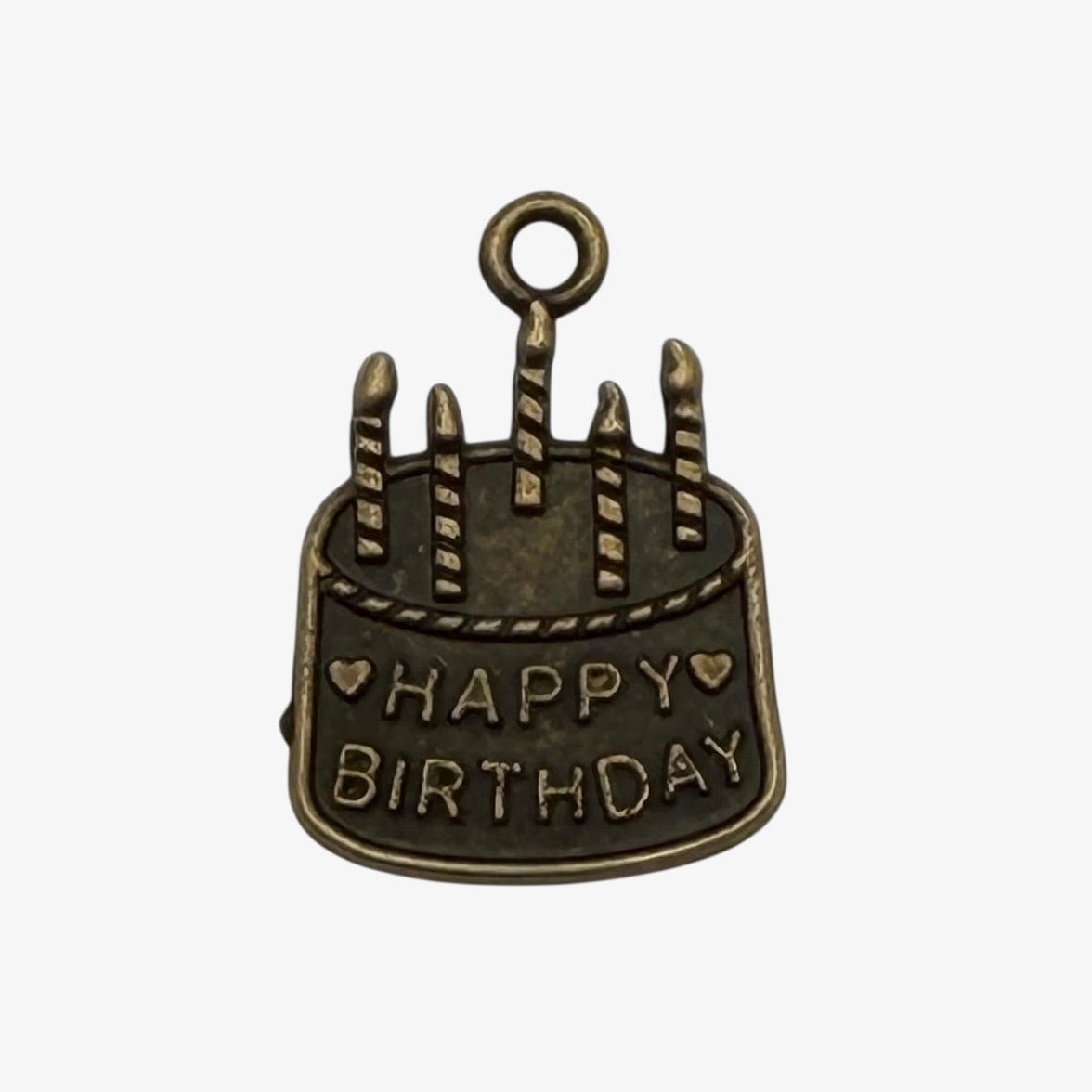 Bronze birthday cake charm with 'Happy Birthday' text on a white background