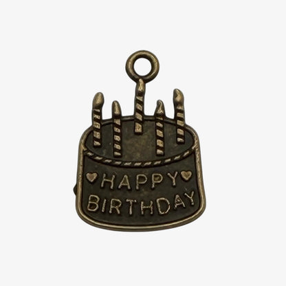 Bronze birthday cake charm with 'Happy Birthday' text on a white background