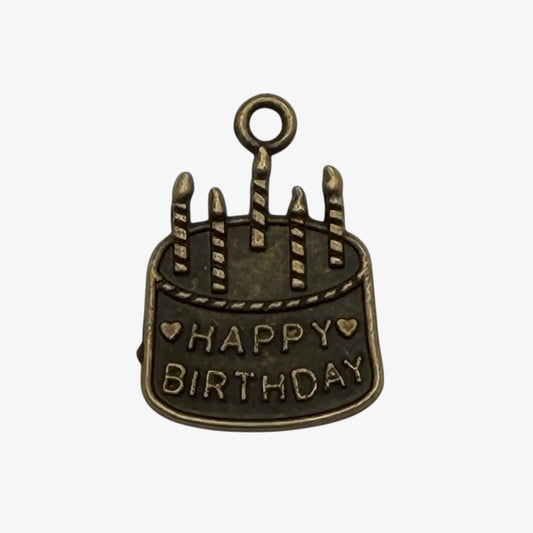 Bronze birthday cake charm with 'Happy Birthday' text on a white background