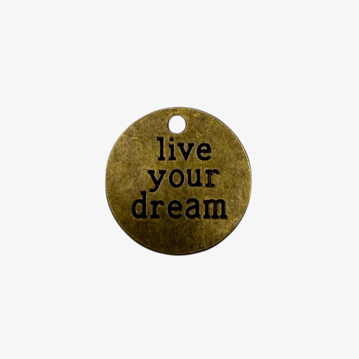 Bronze pendant with 'live your dream' engraving on a white background
