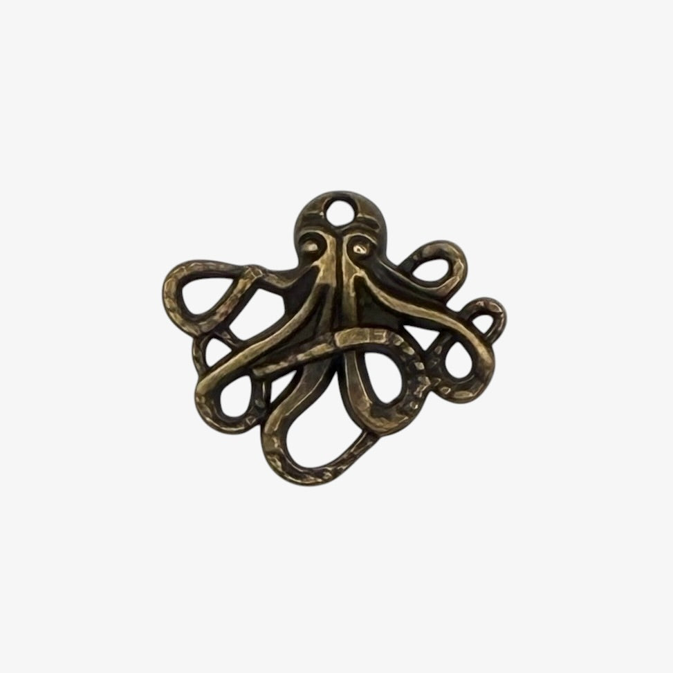 Bronze-colored octopus pendant on a white background