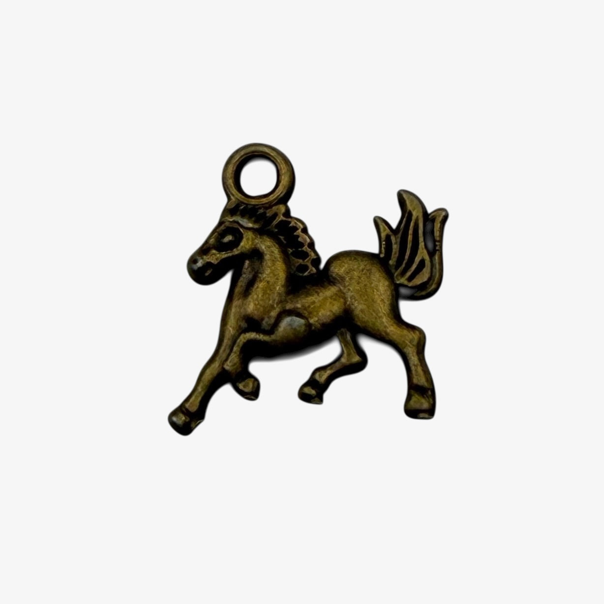 Bronze-colored unicorn charm on a white background