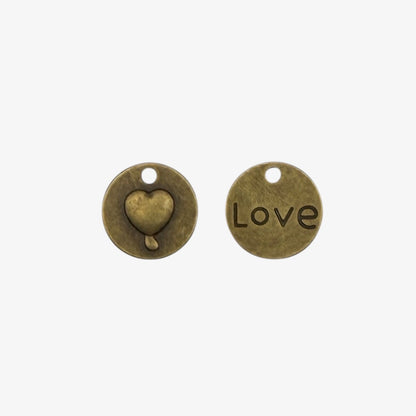 small round charm with a puffy heart on one side and love on the other