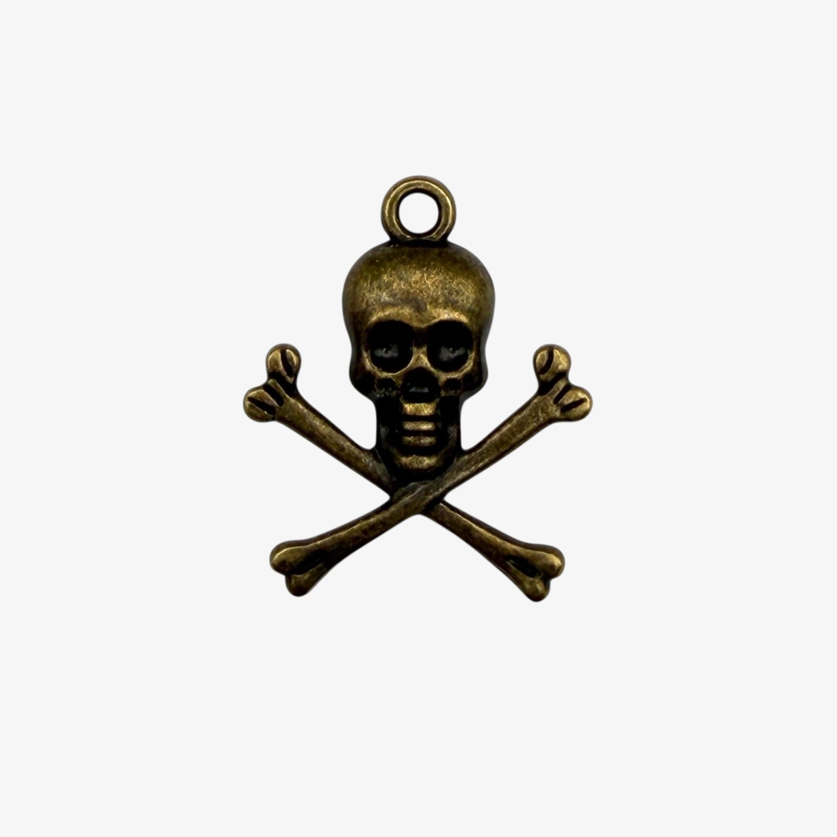 Bronze skull and crossbones pendant on a white background
