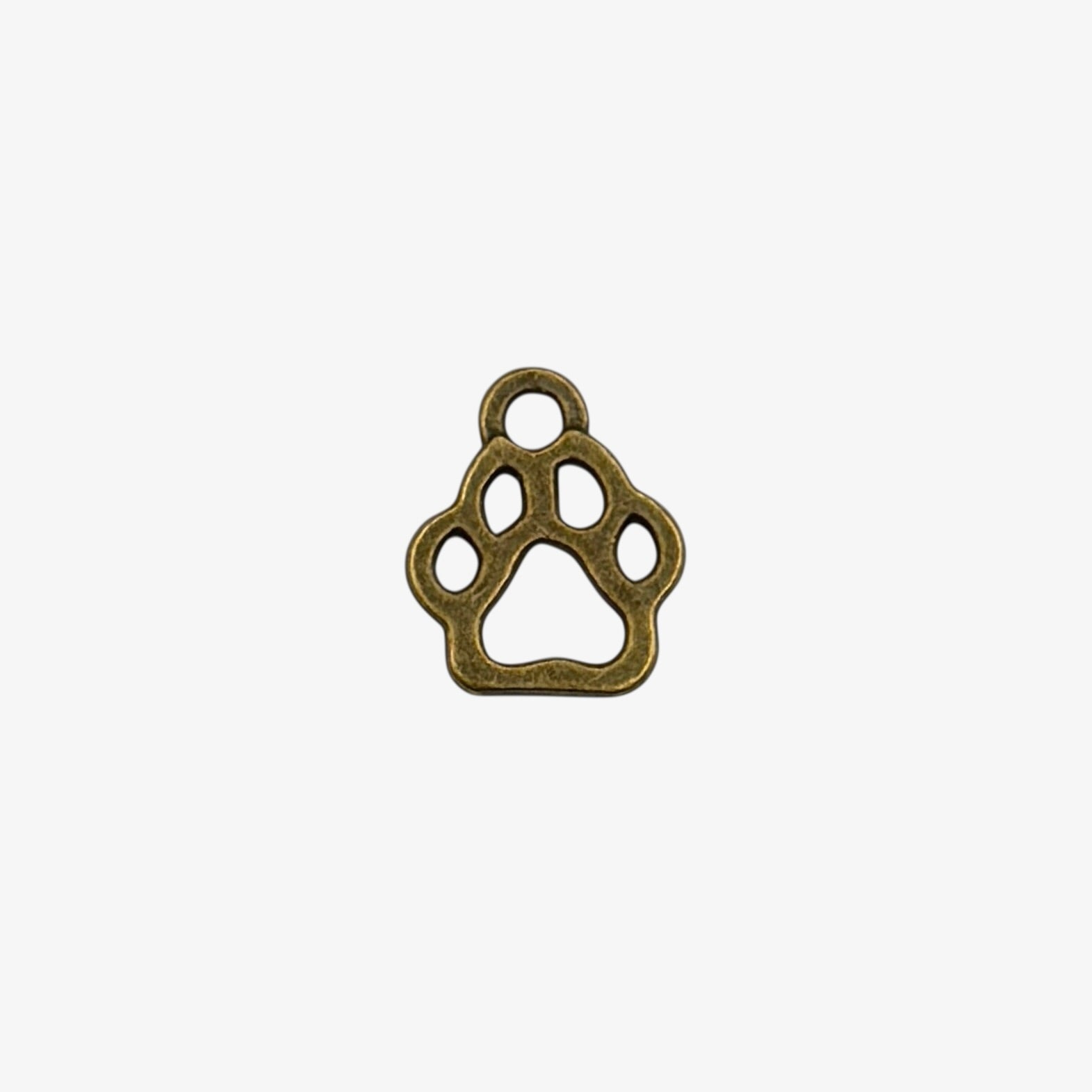 Bronze paw print charm on a white background