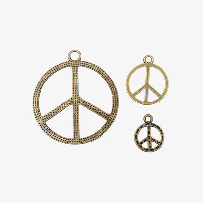 Three peace symbol pendants on a white background