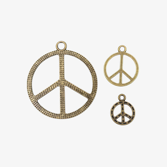 Three peace symbol pendants on a white background