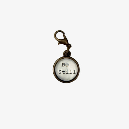 Keychain with 'Be Still' text on a white background