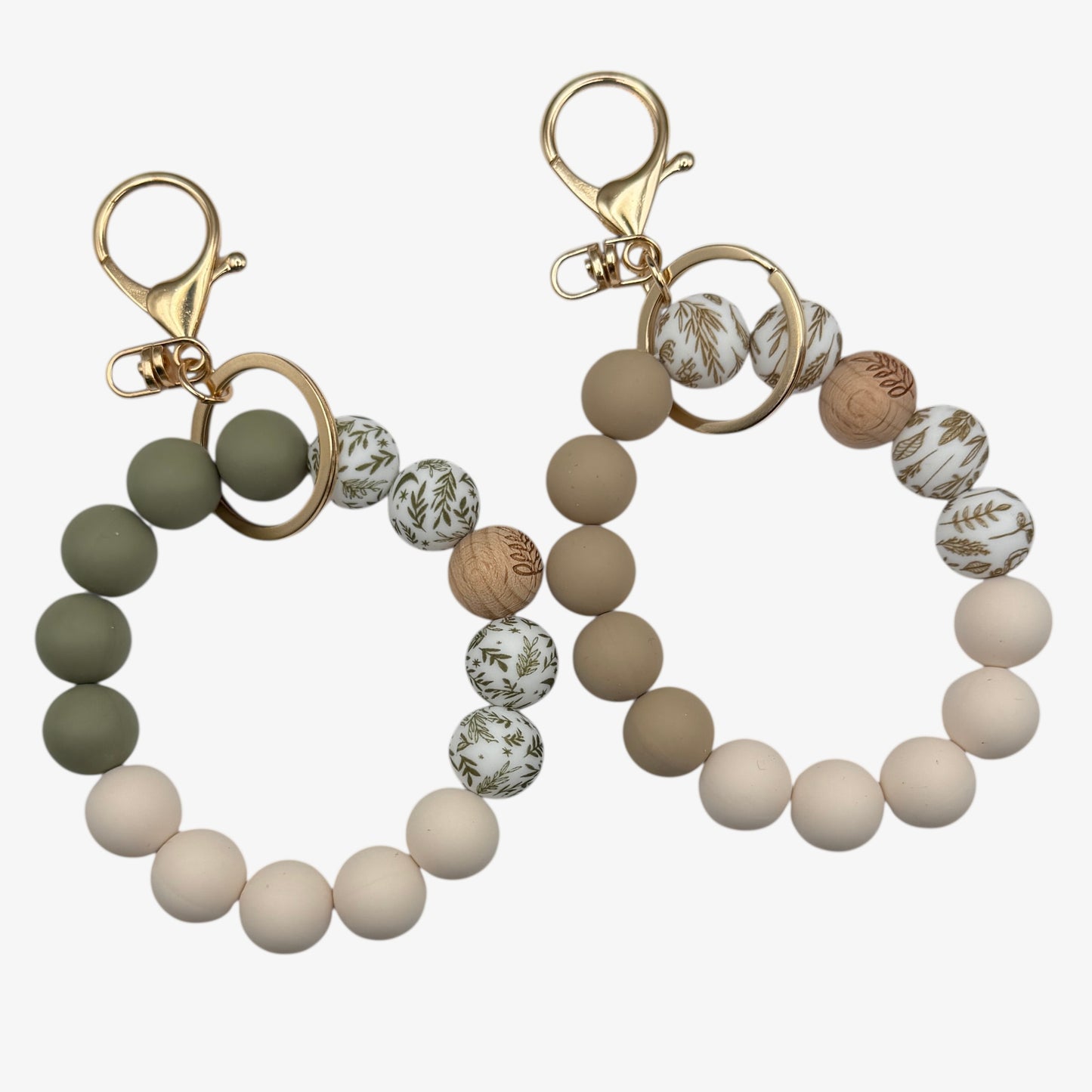 Two beaded keychains with gold clasps on a white background