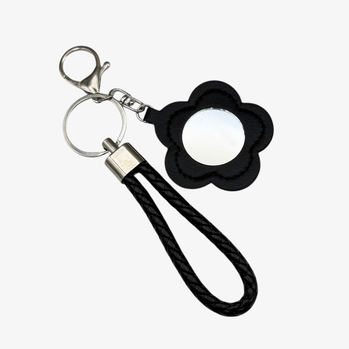 Keychain with black flower-shaped phone holder and black rope strap on a white background