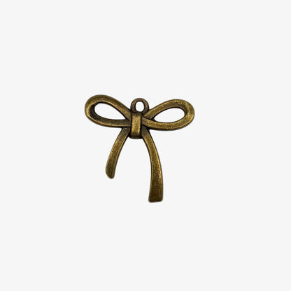 Bronze bow-shaped pendant on a white background