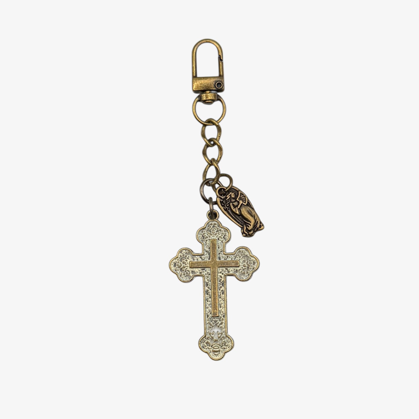 Keychain with cross pendant and small figure on a white background