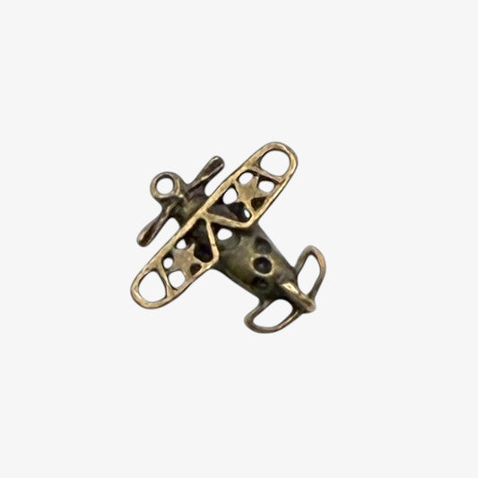 Bronze airplane-shaped pendant on a white background