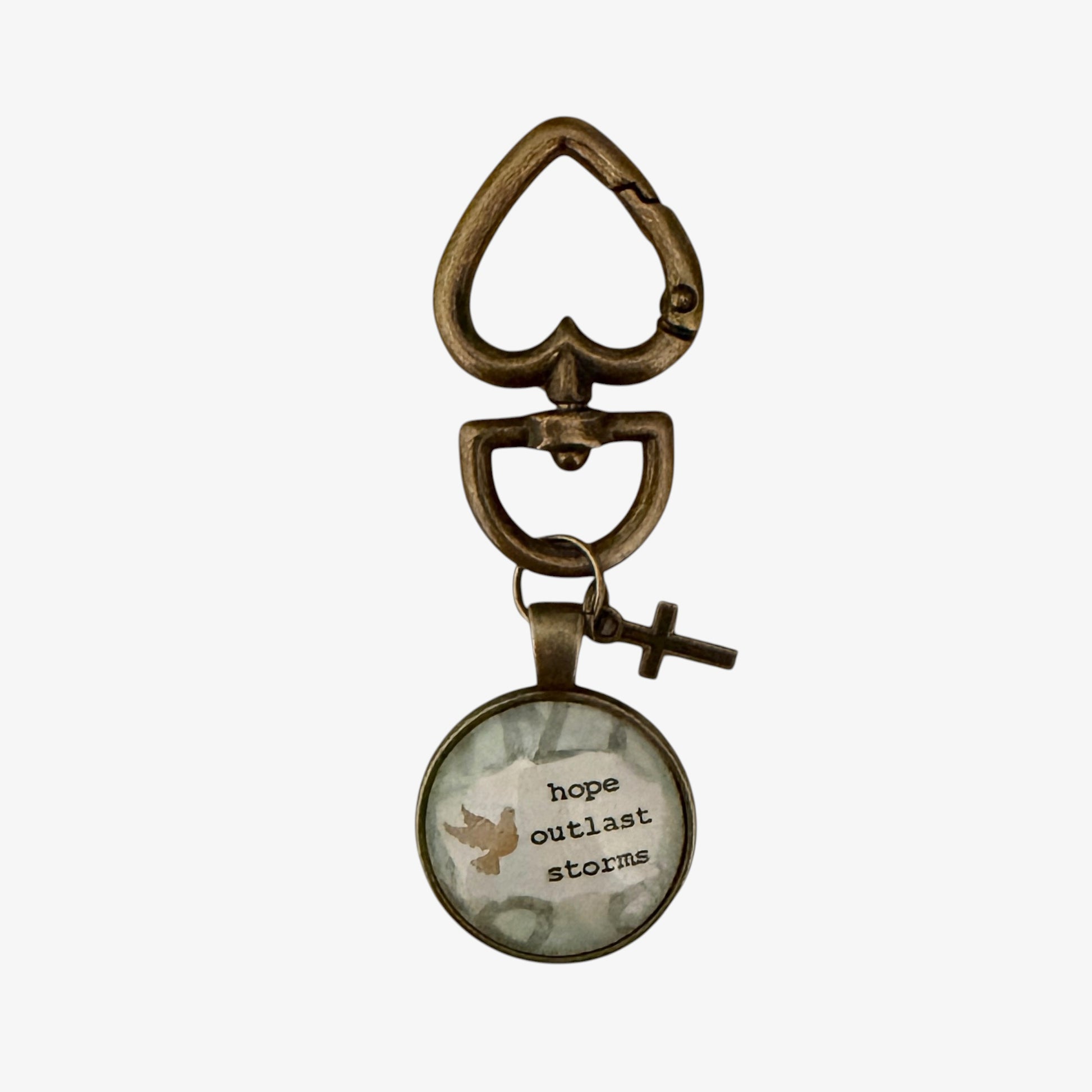 Bronze keychain with a circular pendant featuring text and a bird illustration on a white background