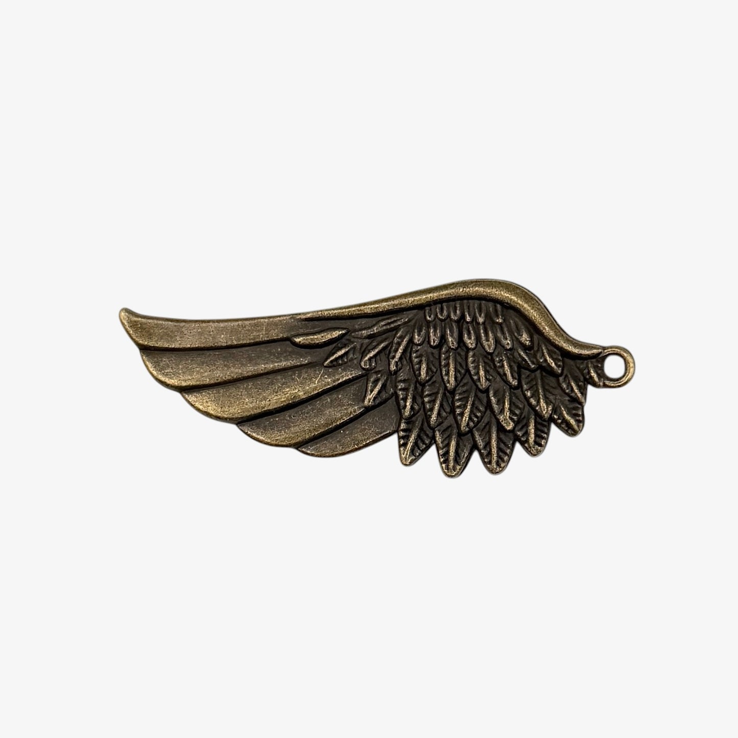 Bronze wing-shaped pendant on a white background