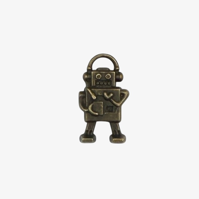 Bronze robot charm on a white background