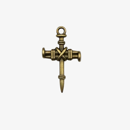 Bronze cross-shaped pendant on a white background