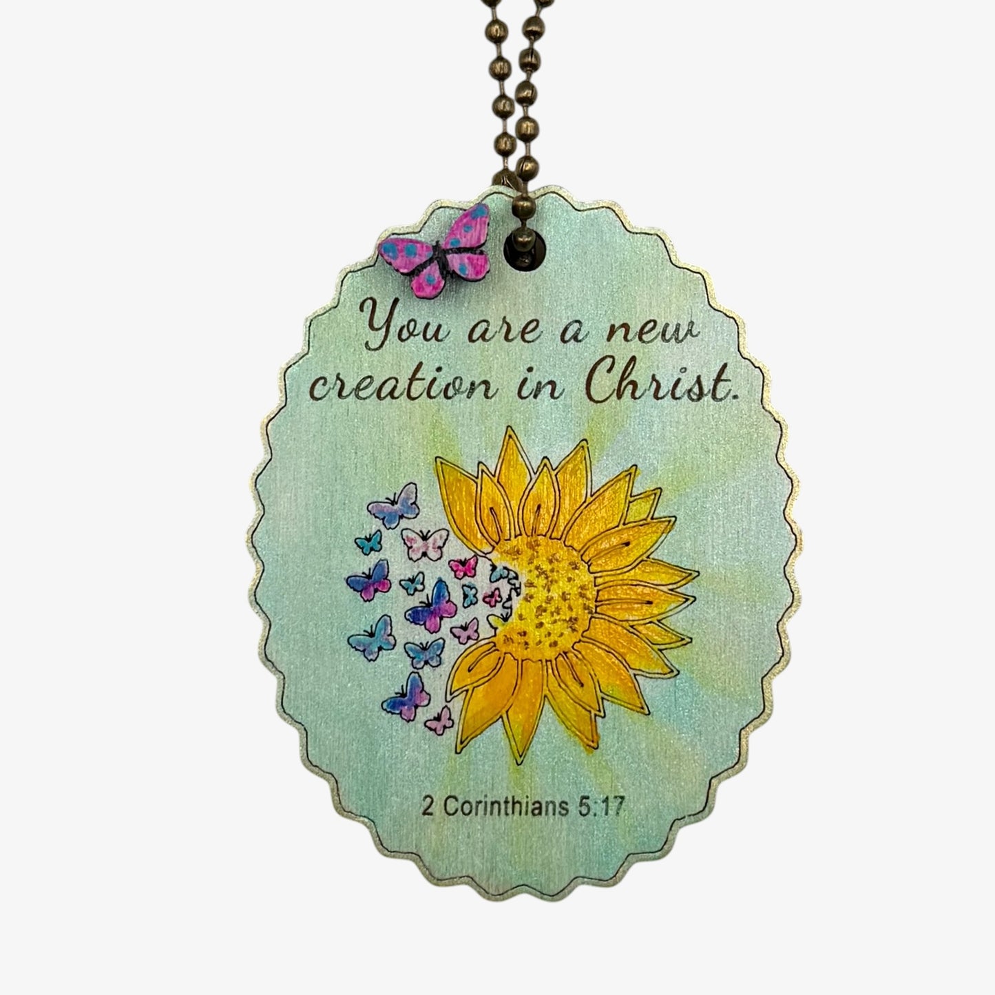 Decorative tag with sunflower, butterflies, and inspirational quote on a white background