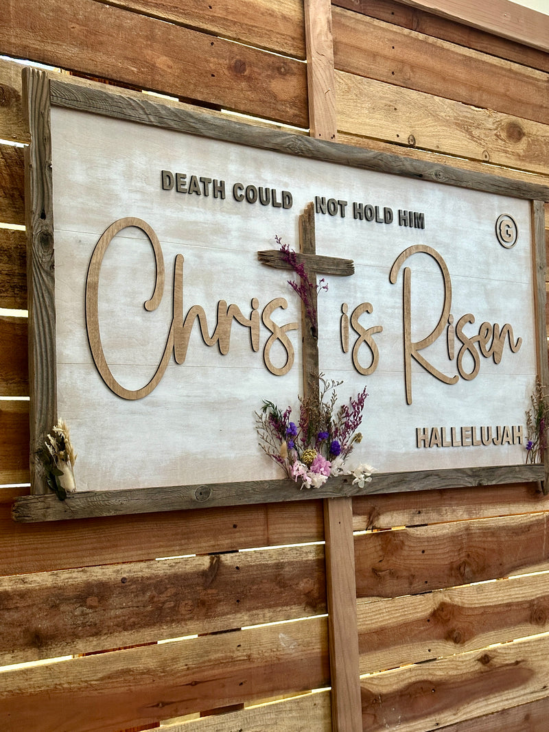 Wooden sign with 'Christ is Risen' on a wooden wall