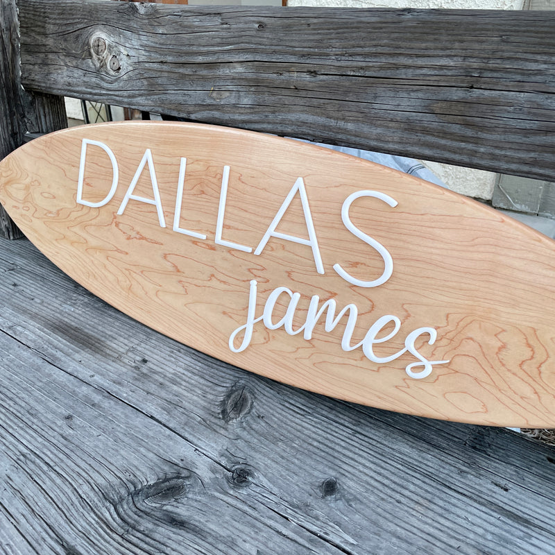 Handmade custom surfboard out of maple hardwood with laser cut acrylic name,