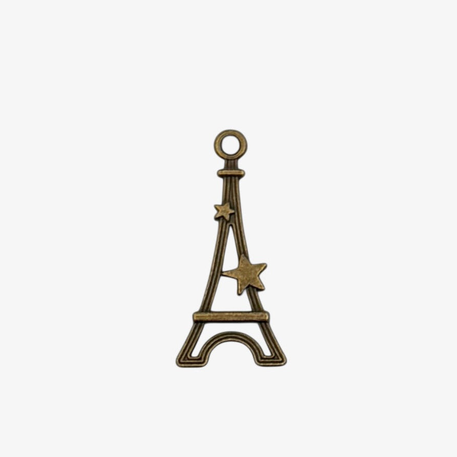 Bronze-colored Eiffel Tower charm on a white background