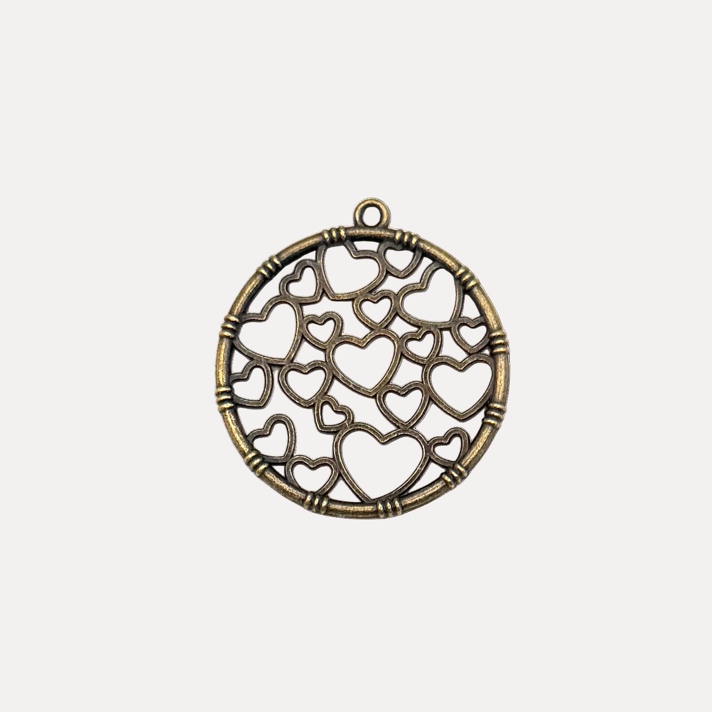 Bronze pendant with heart designs on a white background