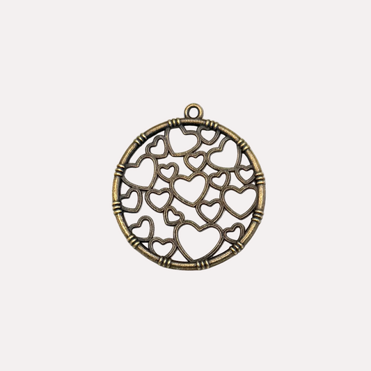 Bronze pendant with heart designs on a white background