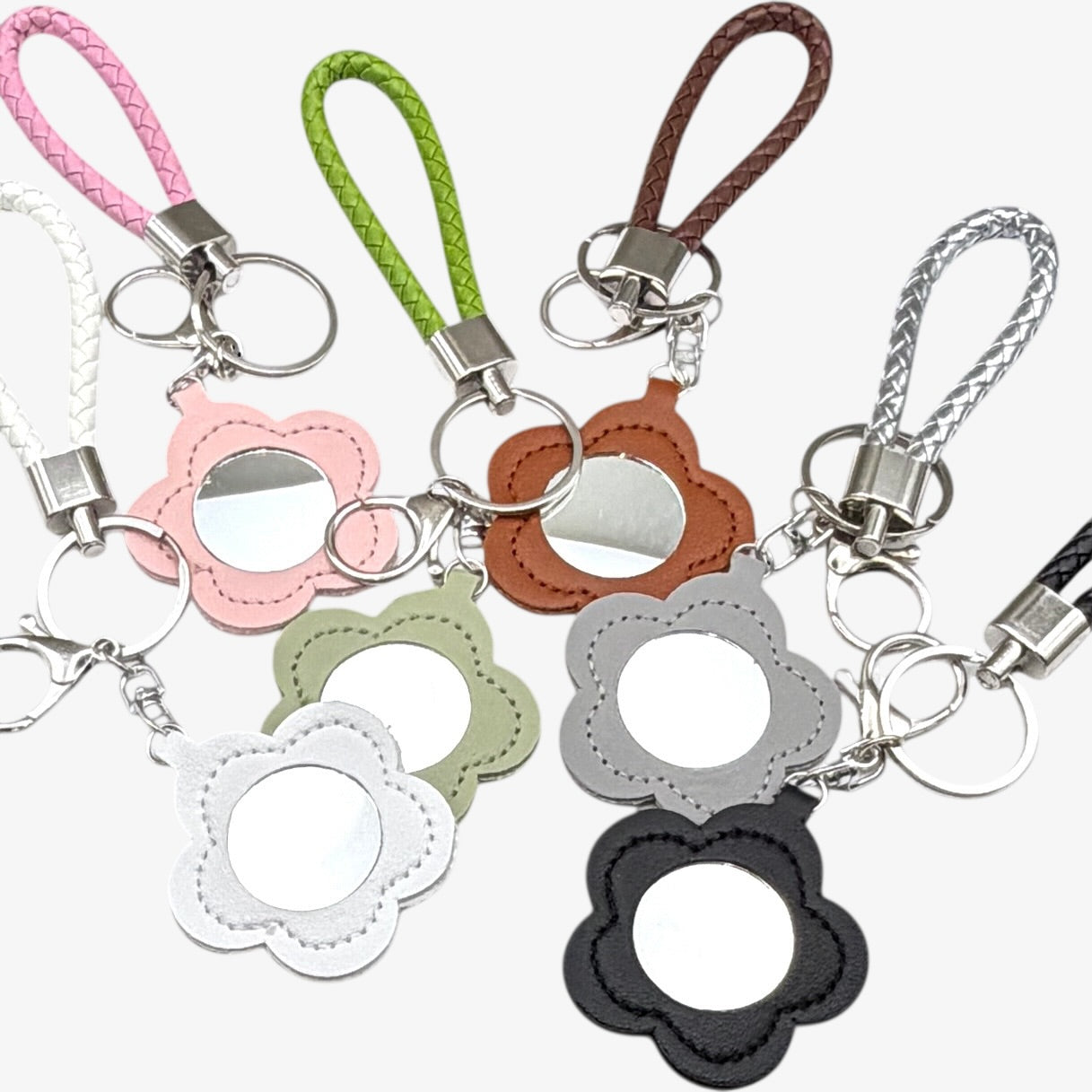 Set of colorful keychains with floral designs on a white background