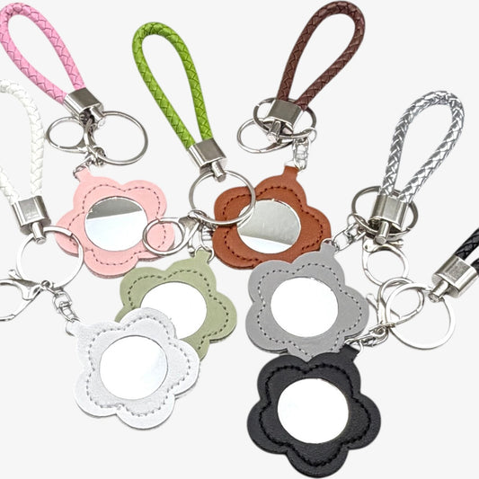Set of colorful keychains with floral designs on a white background