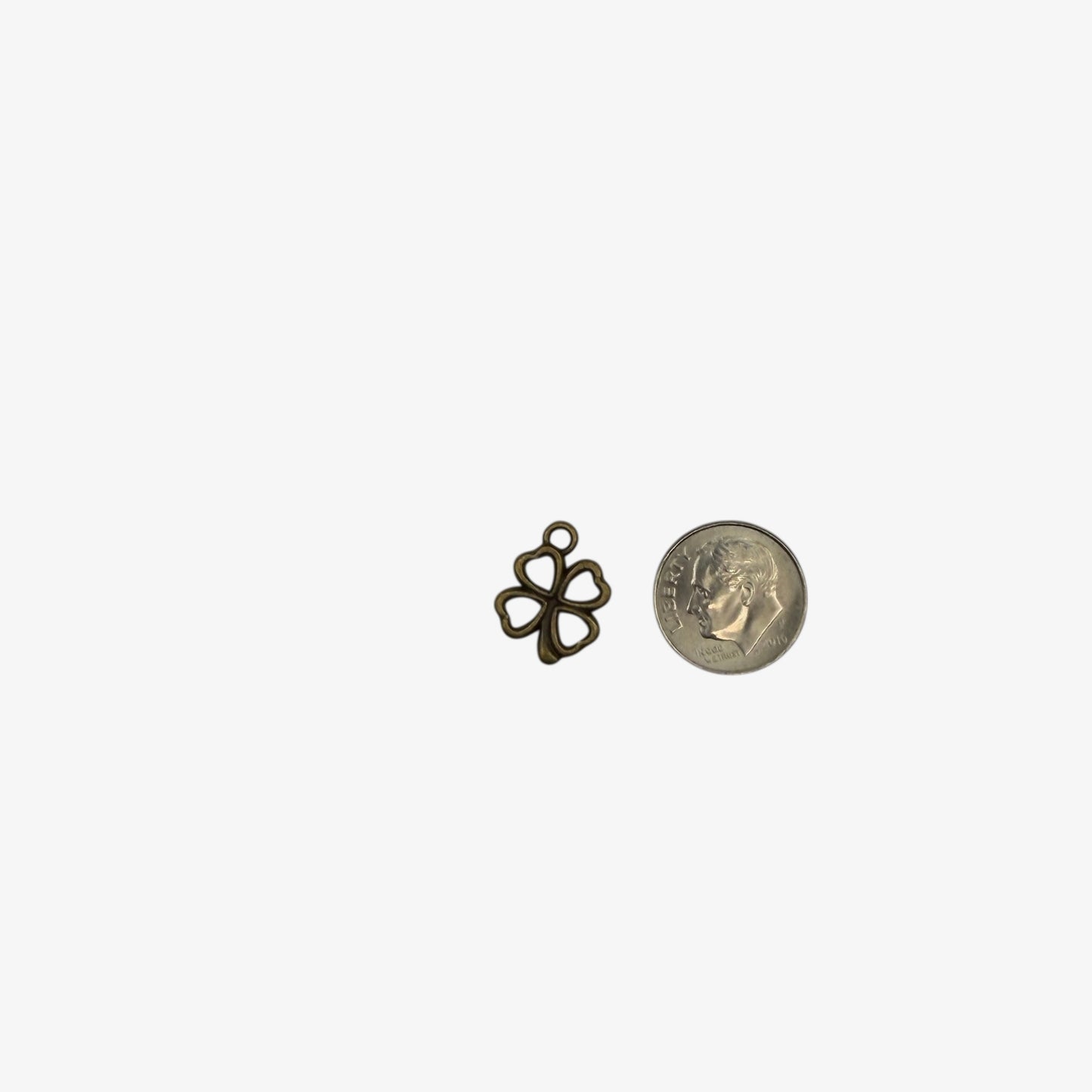 bronze four leaf clover charm on a white background