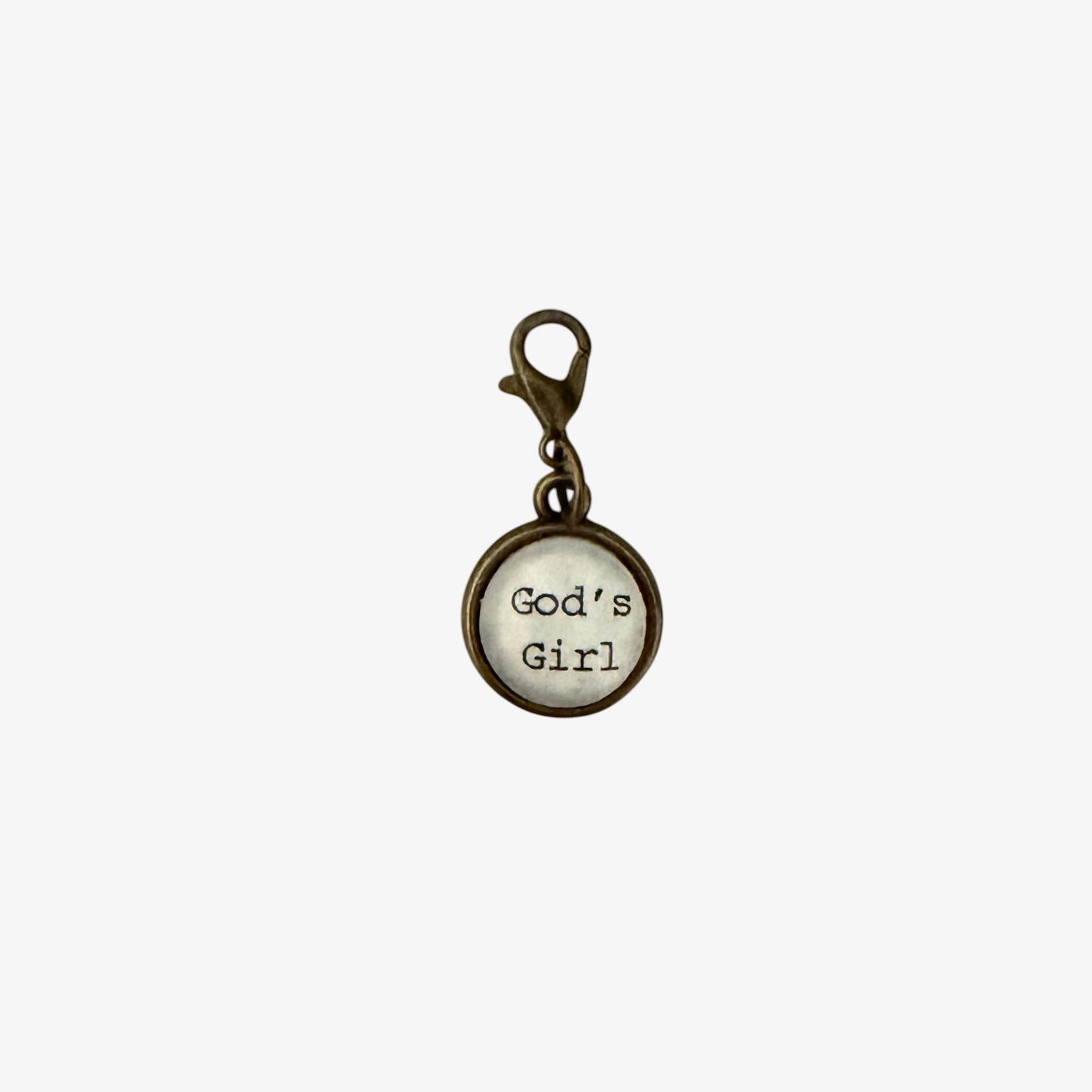 Round charm with 'God's Girl' text on a white background