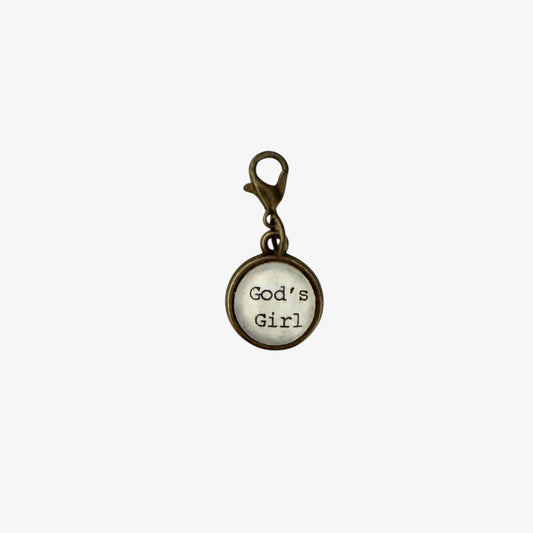 Round charm with 'God's Girl' text on a white background