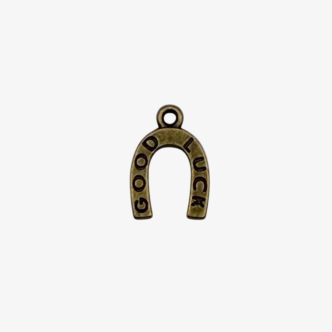 Bronze-colored 'Good Luck' horseshoe charm on a white background