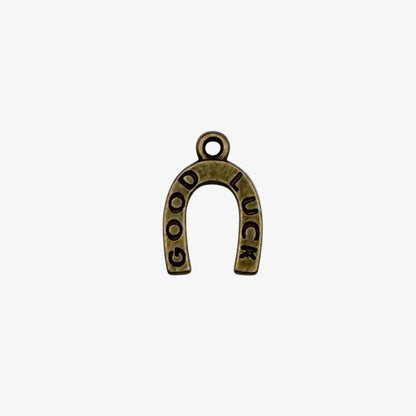 Bronze-colored 'Good Luck' horseshoe charm on a white background