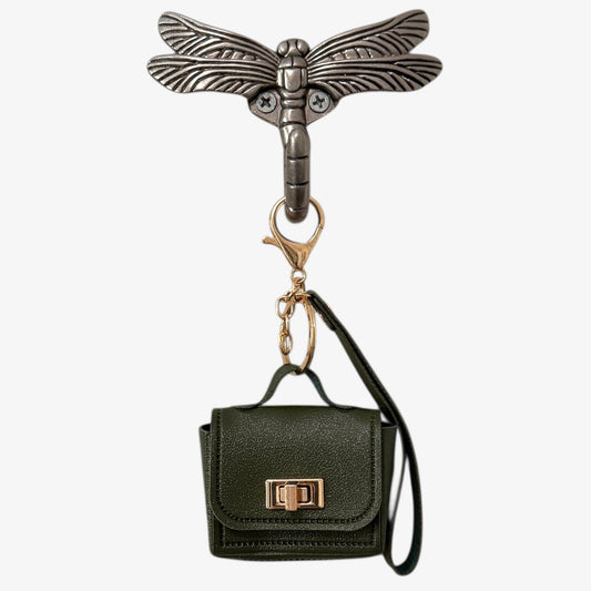 Keychain with a small black handbag and dragonfly design on a white background