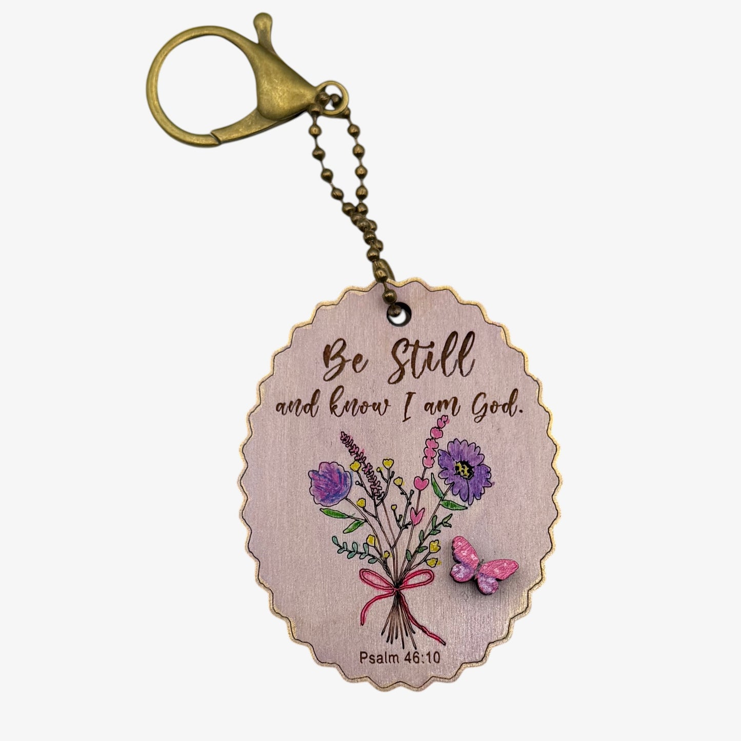 Keychain with floral design and motivational quote on a white background