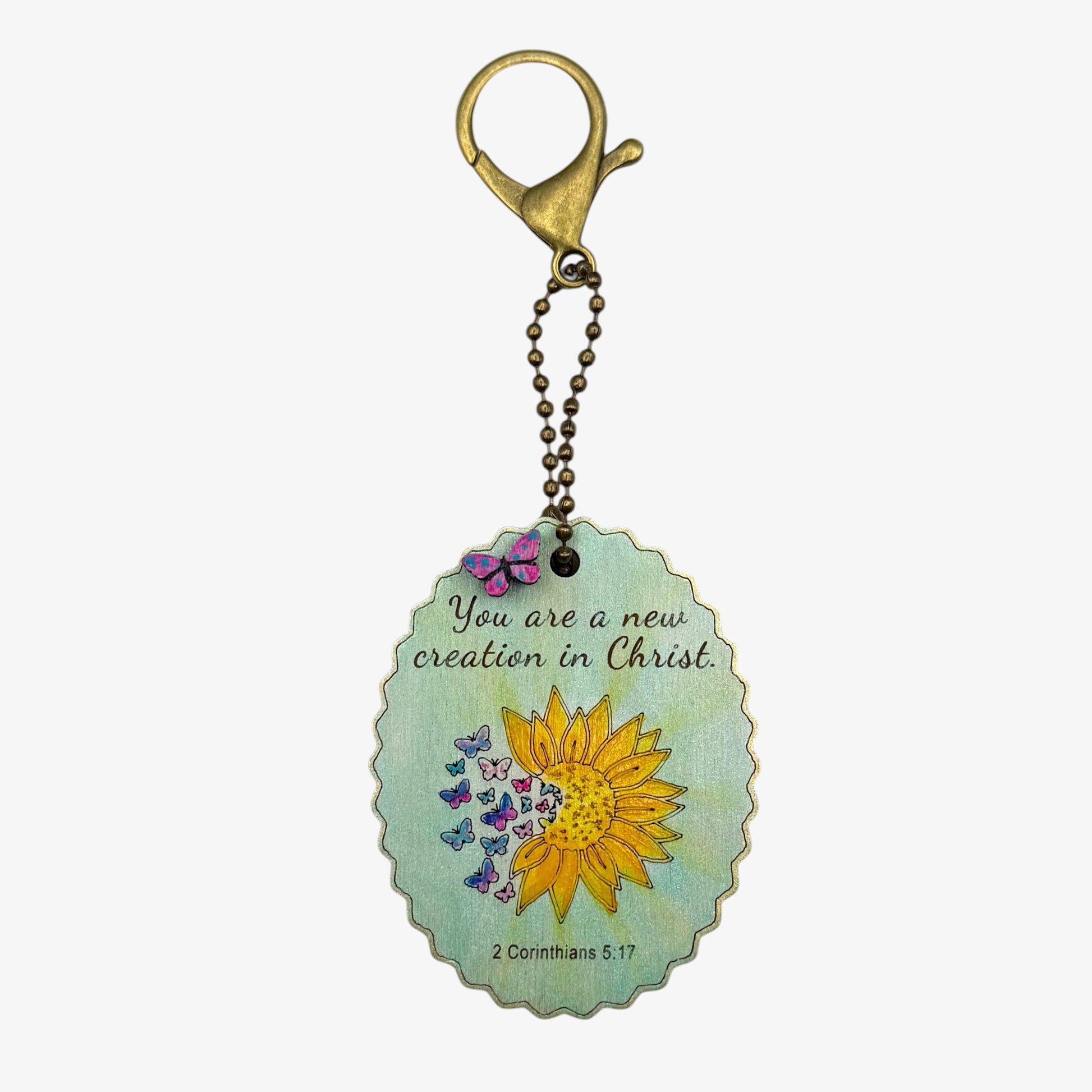 Keychain with sunflower design and inspirational quote on a light blue background