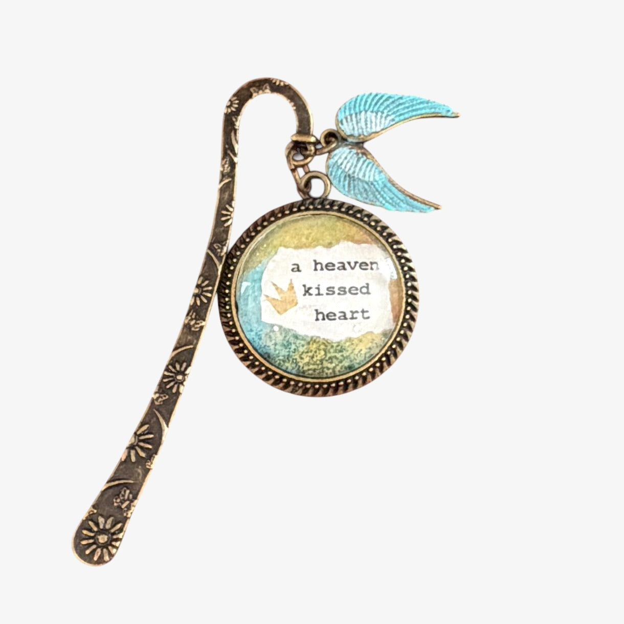 Decorative bookmark with a heart design and text on a white background